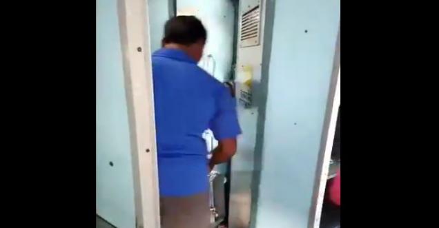 Indian Railway staff filling tea kettles with toilet water