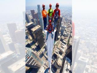 group of 5 people, raising gang, on top of a skyscraper